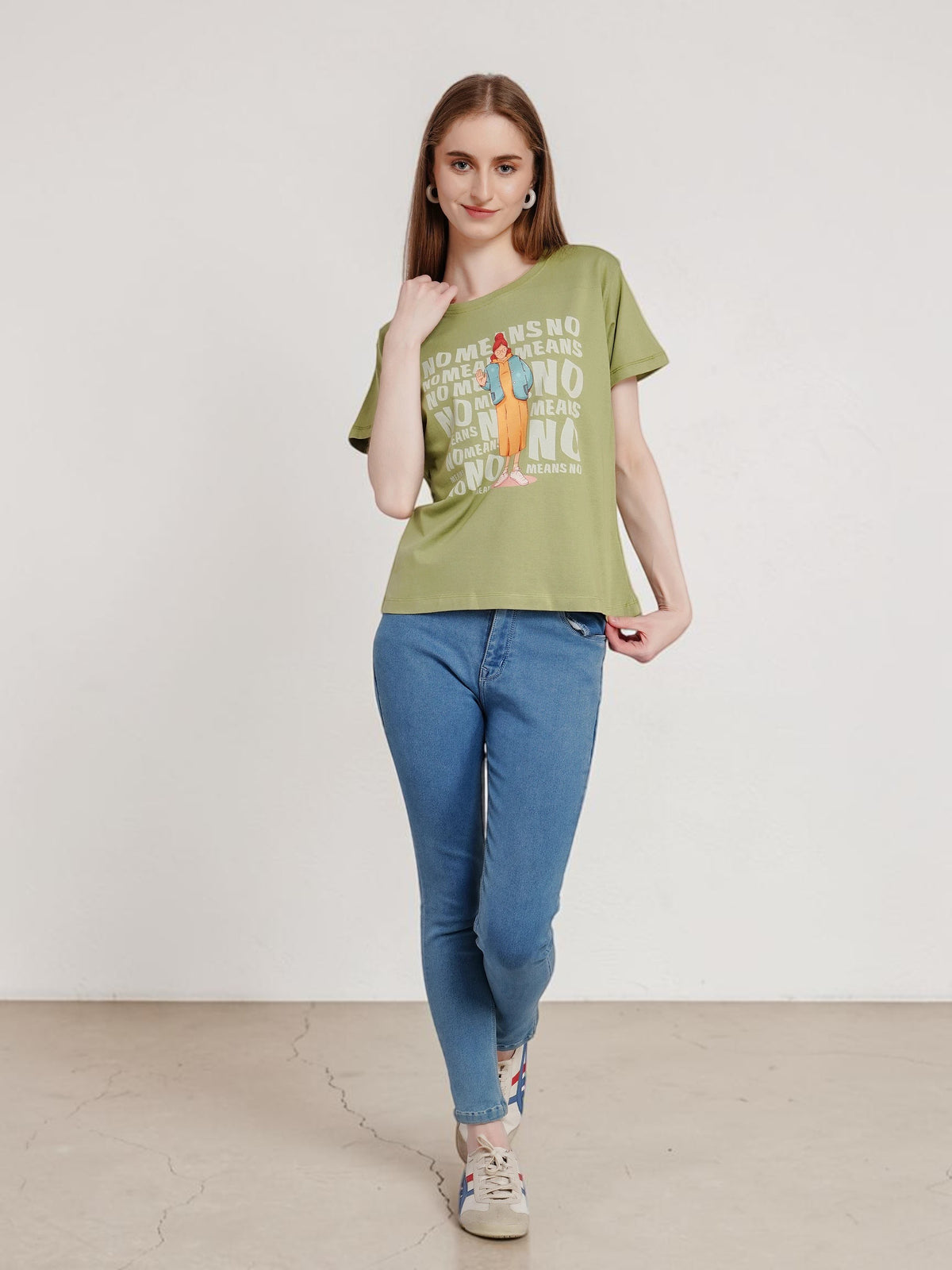 Model wearing an enaay.com olive green cotton t-shirt with a No Means No graphic print and relaxed fit with blue jeans