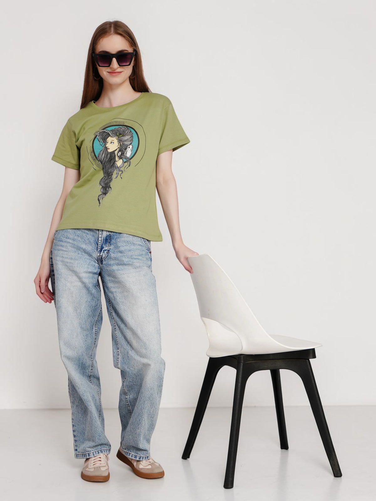 enaay.com olive green Mystic Muse graphic cotton t-shirt worn by a woman with sunglasses and blue jeans