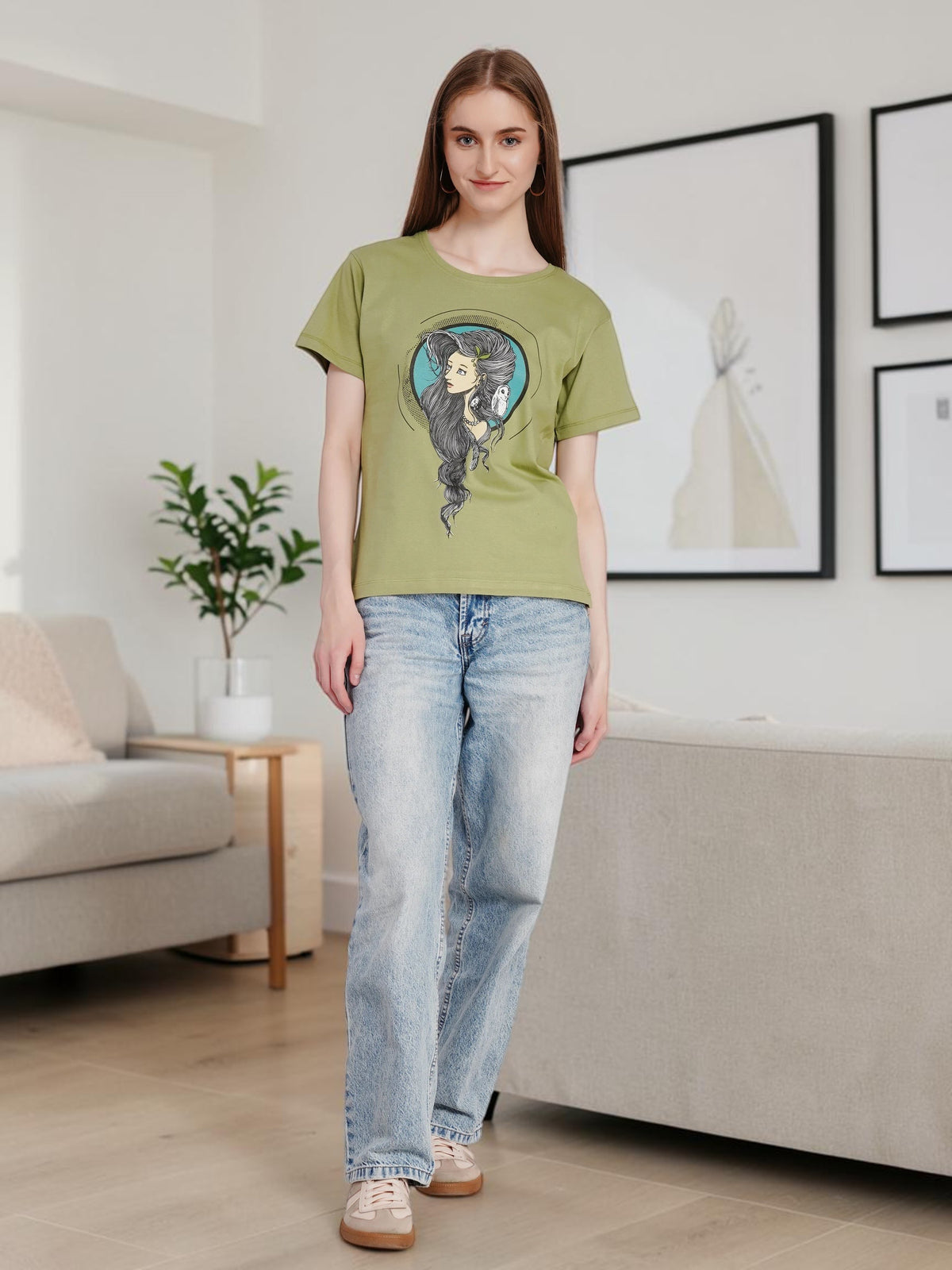 enaay.com women's olive green cotton t-shirt featuring a Mystic Muse graphic print, worn with light wash jeans.