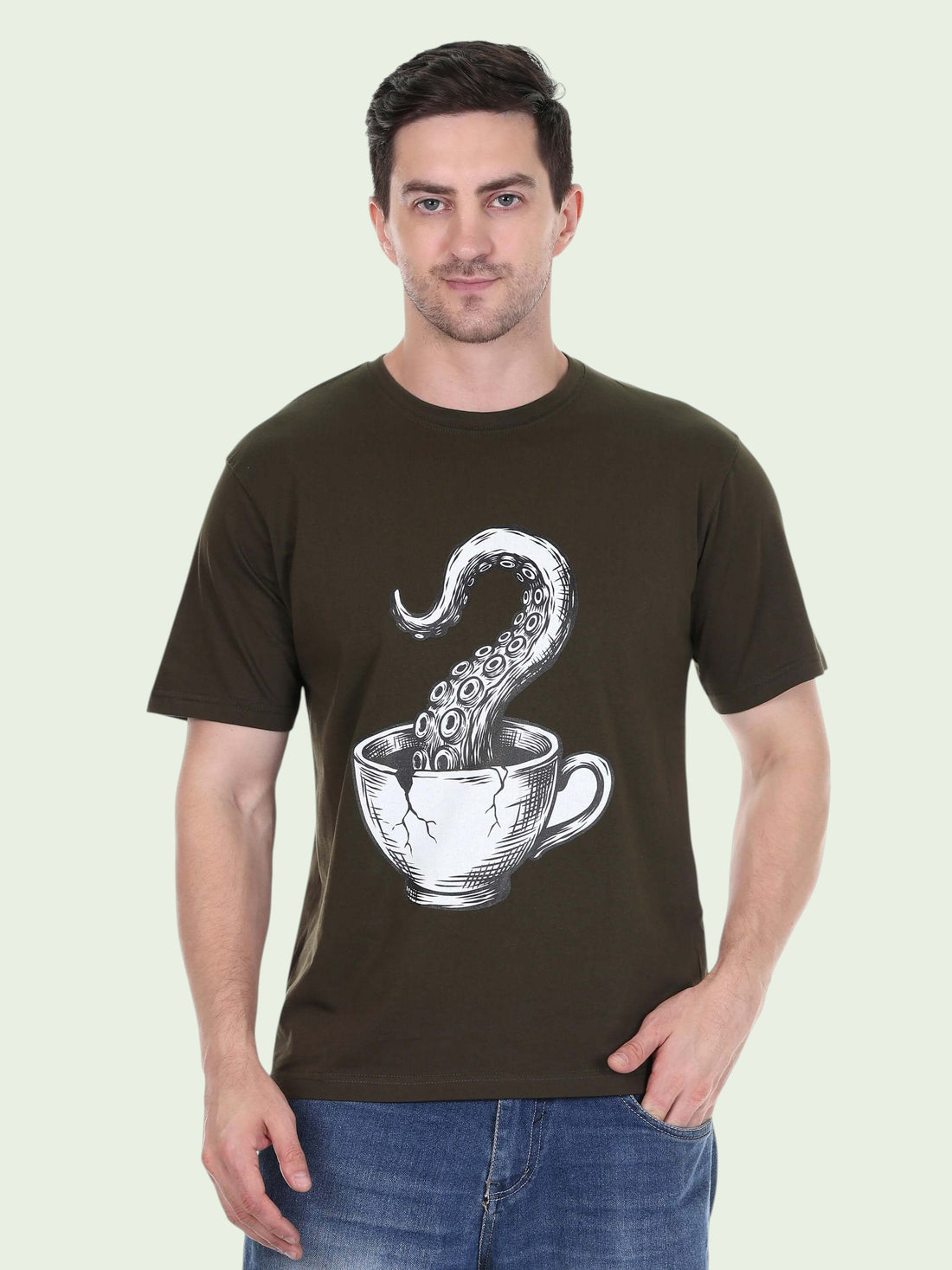 Model wearing an enaay.com olive green cotton t-shirt with a surreal octopus tentacle and coffee cup graphic print