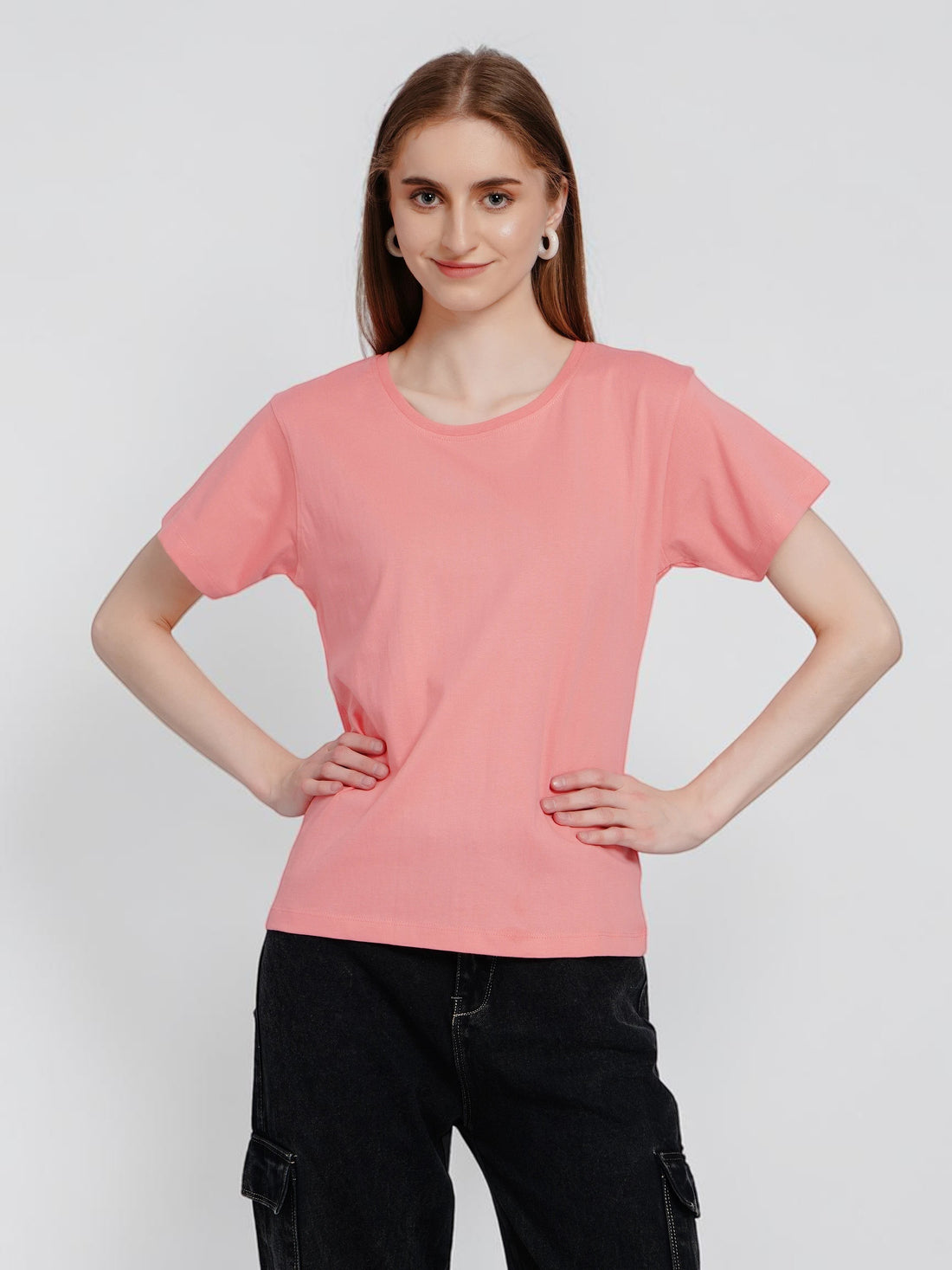 Model wearing an enaay.com peach pink round neck cotton t-shirt with short sleeves and a regular fit.