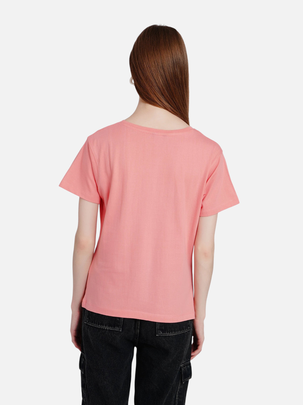 Back view of a woman wearing an enaay.com pink cotton crew neck t-shirt with short sleeves and black jeans.