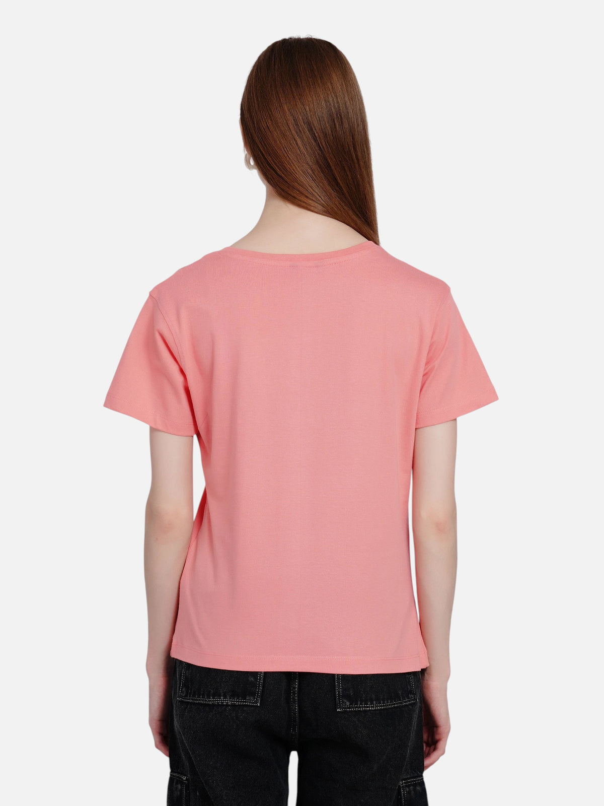 Back view of a woman wearing an enaay.com coral pink cotton round neck t-shirt with black cargo pants