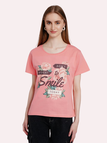Model wearing an enaay.com pink cotton crew neck t-shirt with a floral Don't Forget To Smile Today graphic print