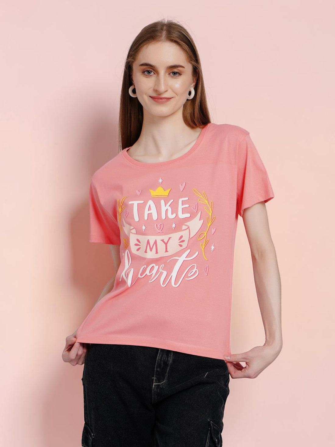 Model wearing an enaay.com coral pink cotton round neck t-shirt with a Take My Heart graphic print and short sleeves.