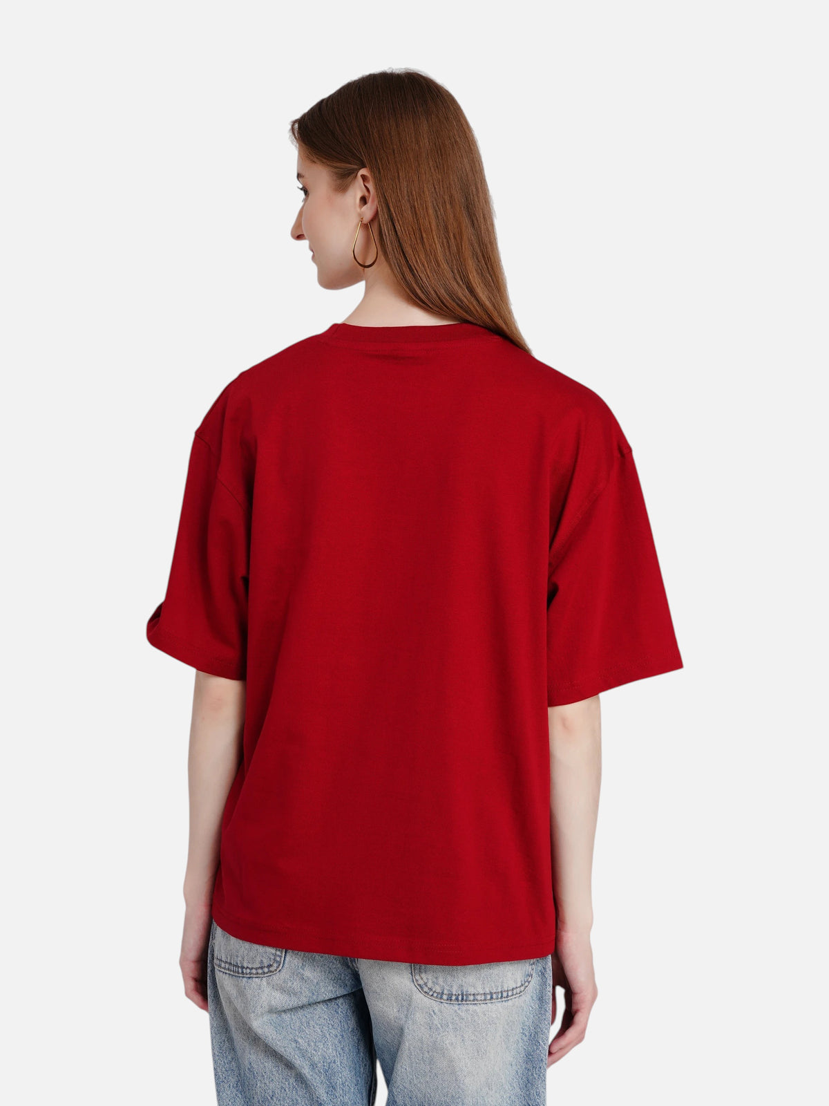 Back view of a woman wearing an enaay.com red solid oversized cotton t-shirt with jeans against a white background