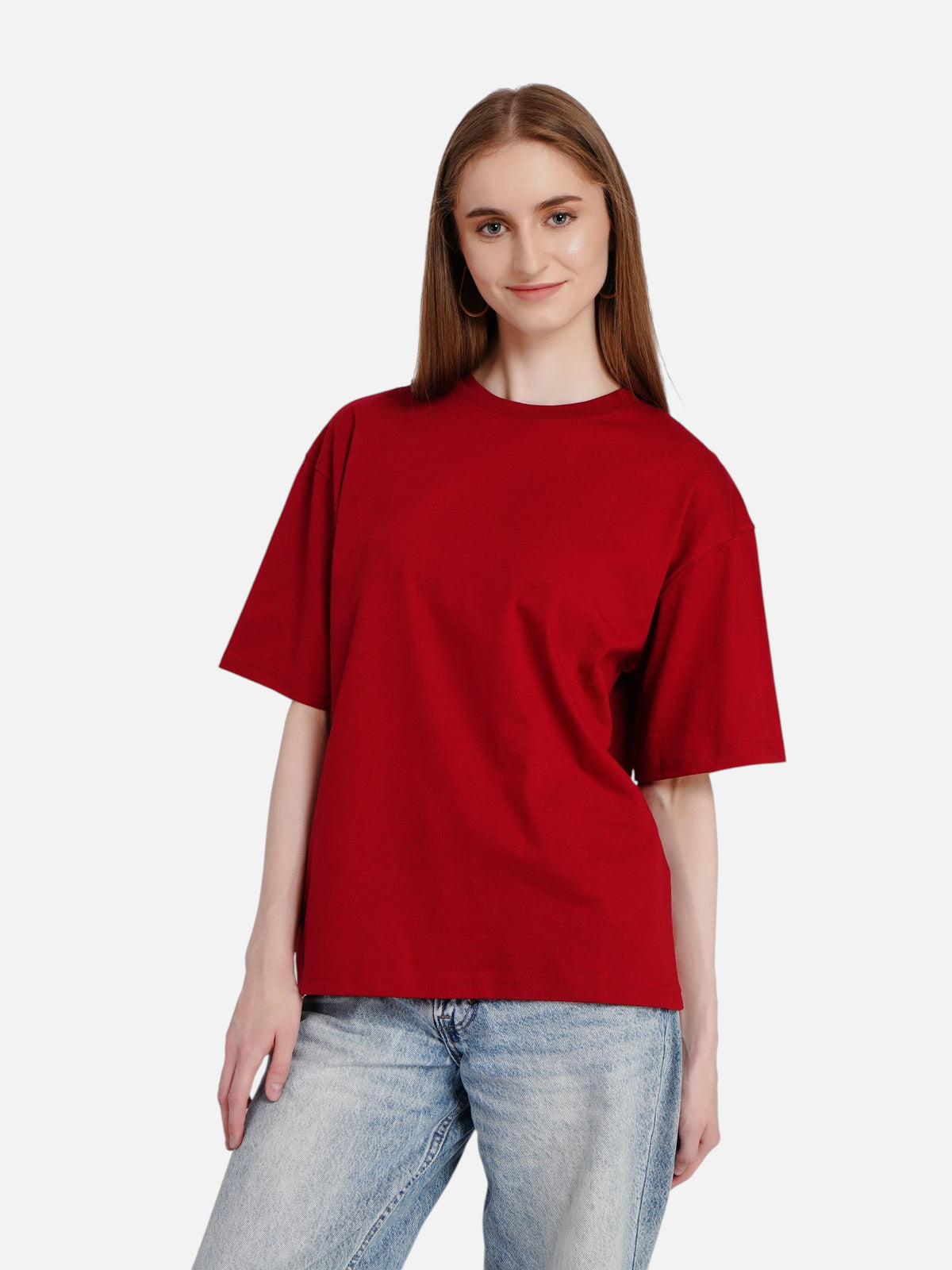 Model wearing an enaay.com women's solid red oversized premium cotton t-shirt with light wash jeans