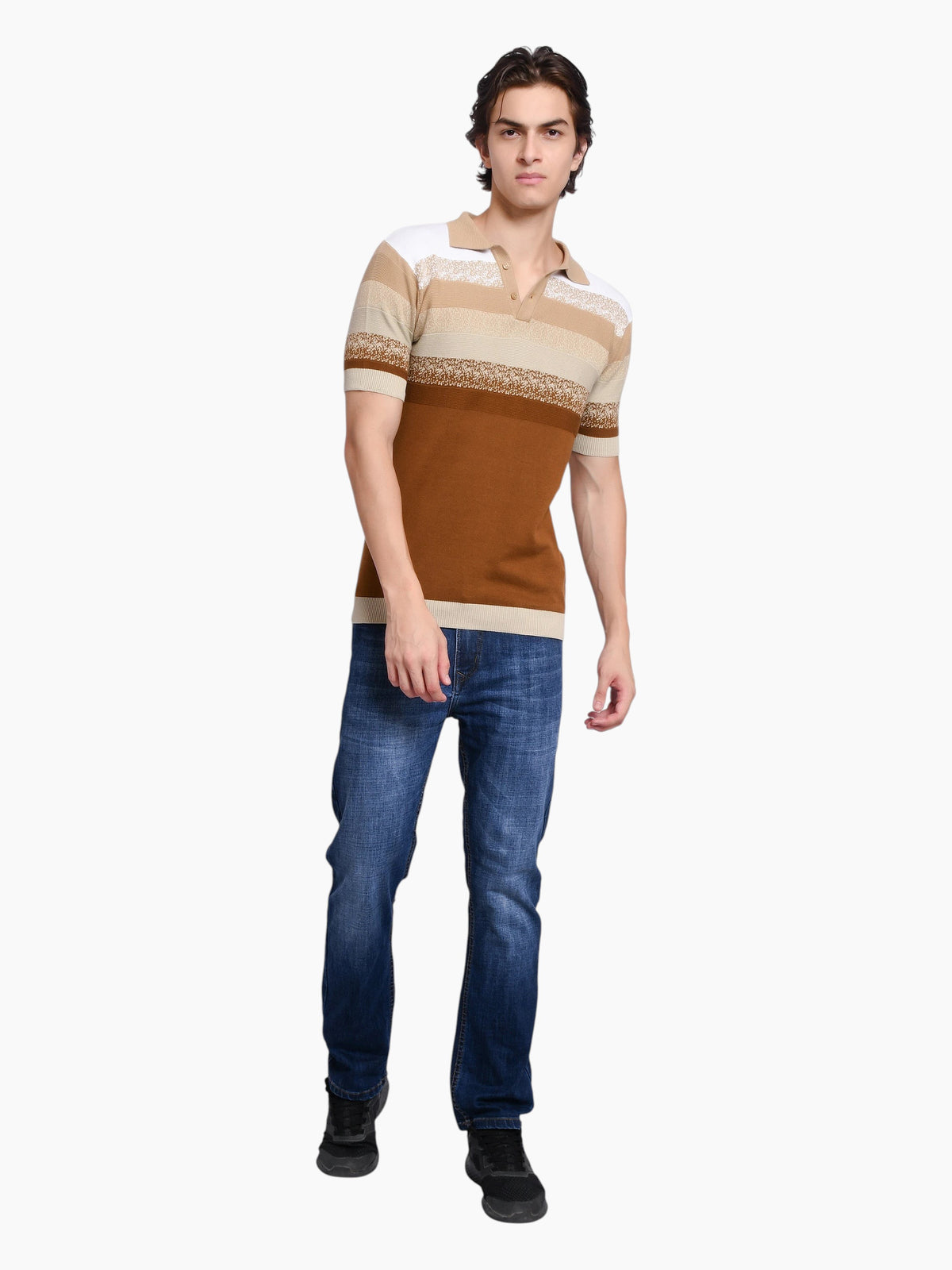 A man wearing an enaay.com striped knit polo shirt in white, beige, and brown with blue jeans against a white background