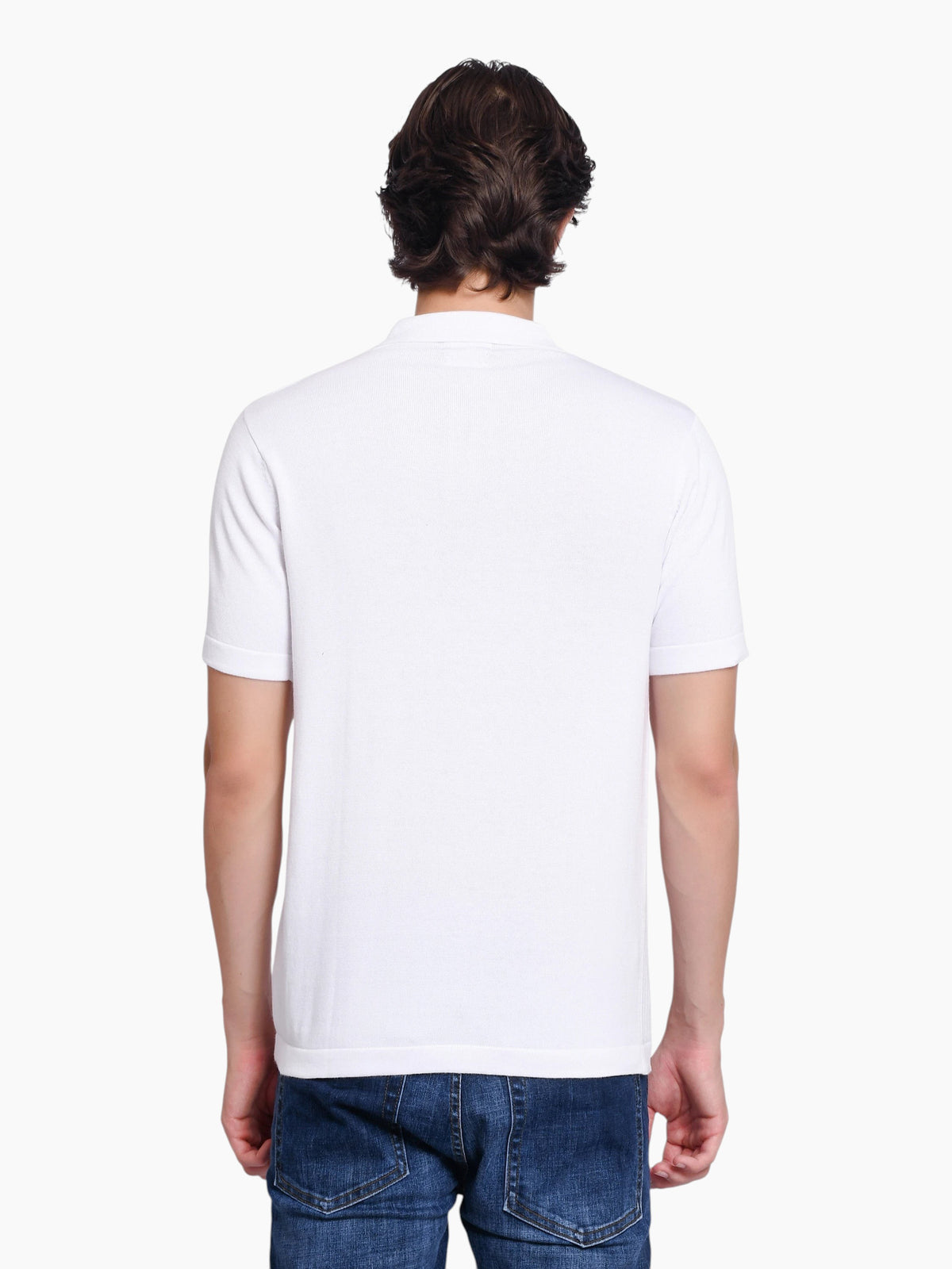 Back view of a man wearing an enaay.com white knit polo shirt with short sleeves and blue jeans