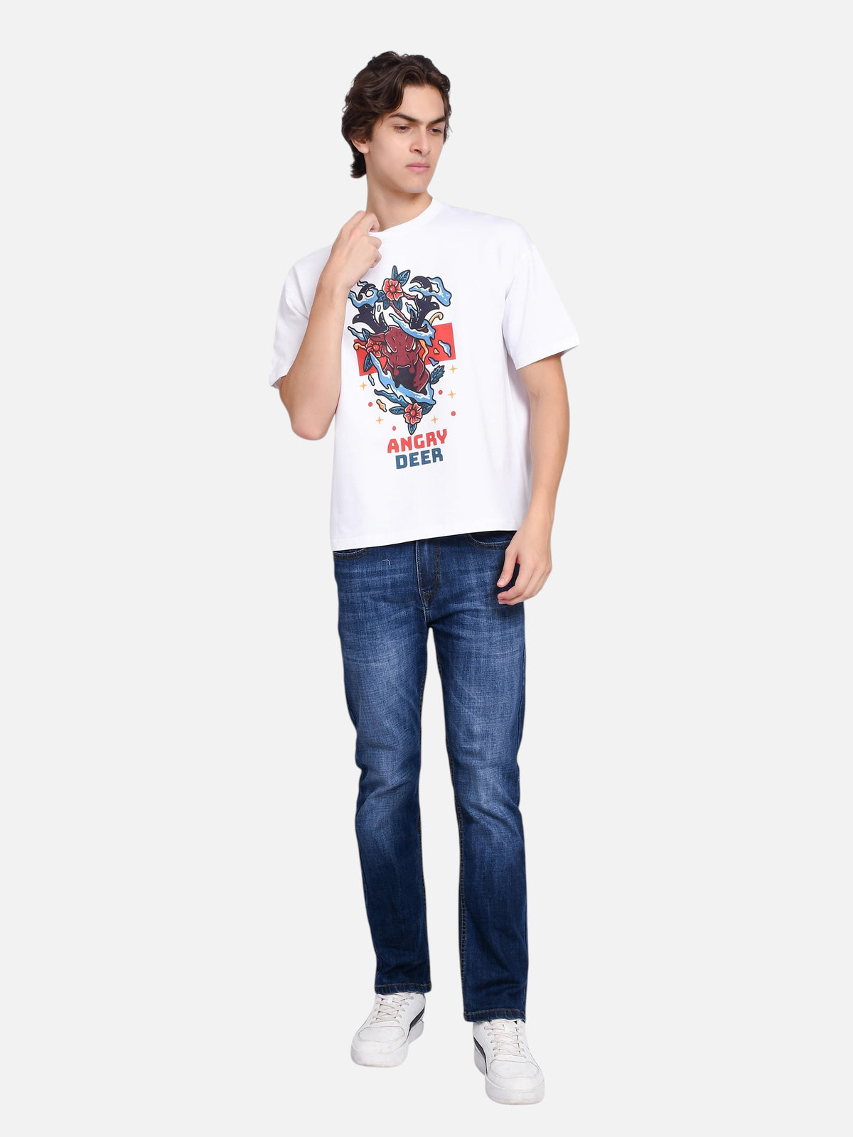 Model wearing enaay.com white oversized t-shirt with angry deer graphic print, paired with blue jeans and sneakers.