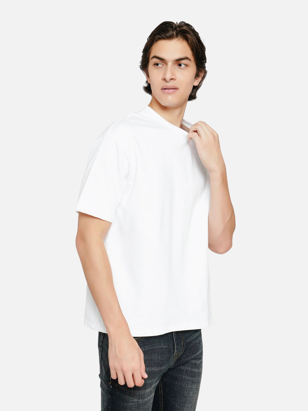 Model wearing an enaay.com white oversized crew-neck t-shirt with dropped shoulders and a relaxed fit